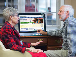 man-and-woman-in-discussion-in-front-of-computer