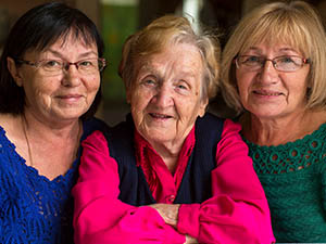 three-women-smiling-looking-at-camera