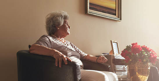 Older Adult looking out window