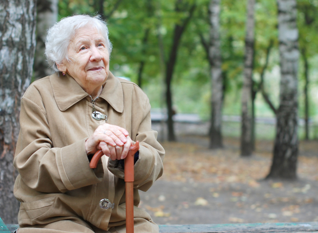 Older woman outside on bench