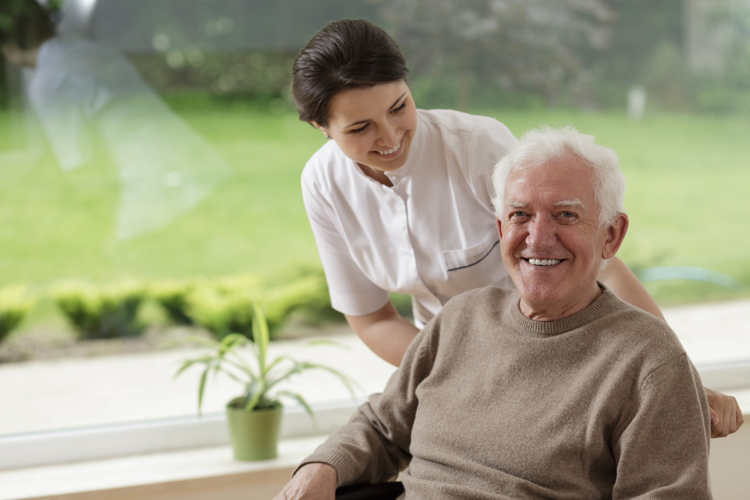 Man staying in nursing home Nurse with Older Adult