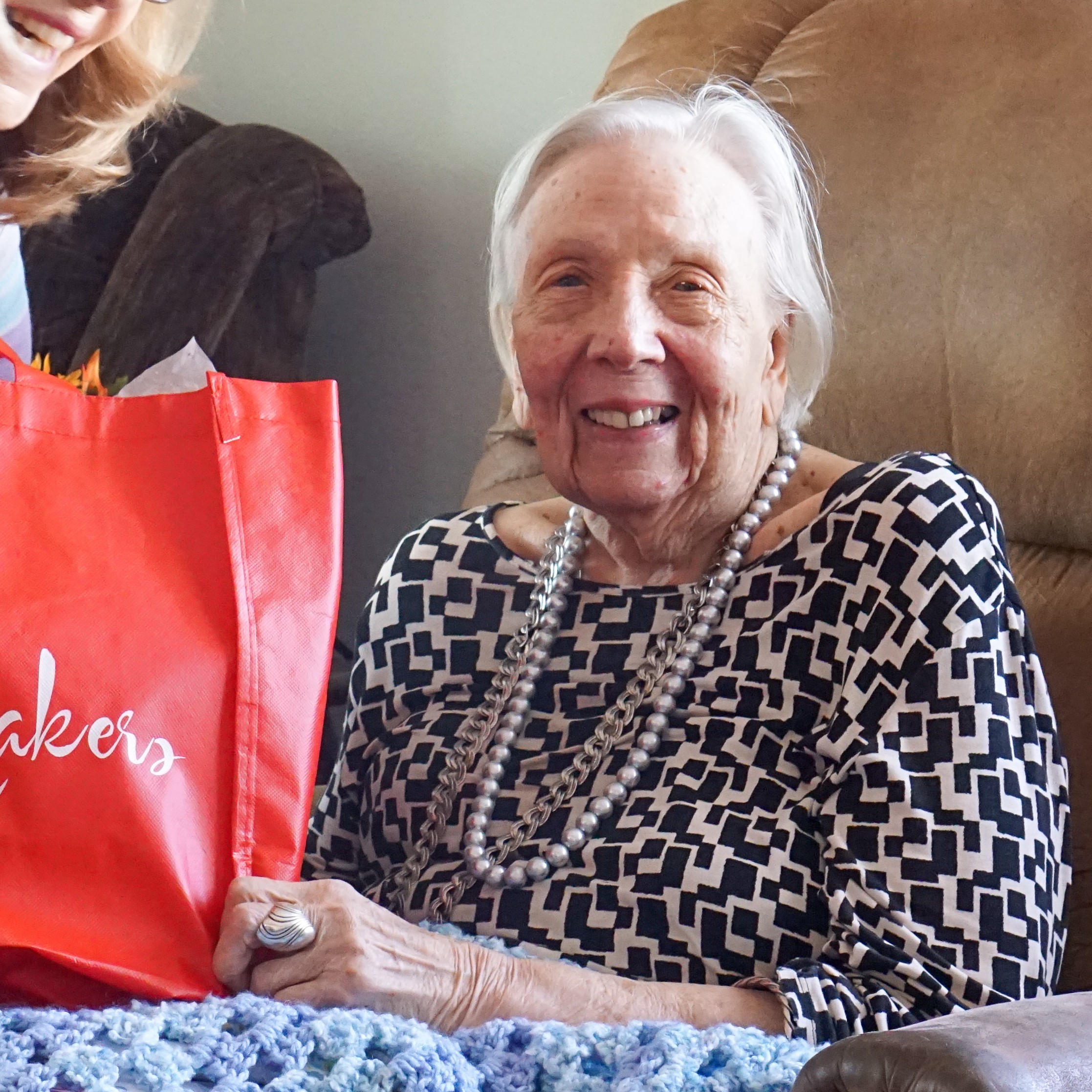 smiling-woman-with-gift-bag