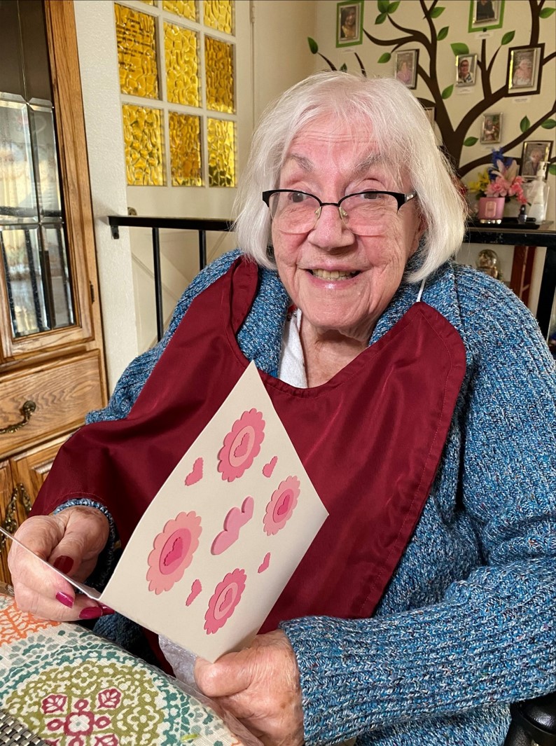 older woman holding valentine's day card